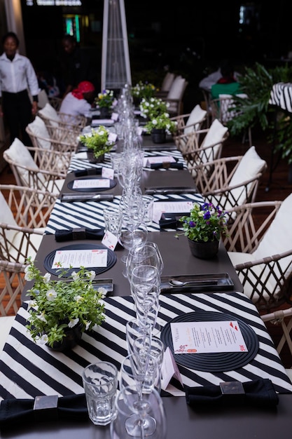 a table with a black and white tablecloth with a menu on it