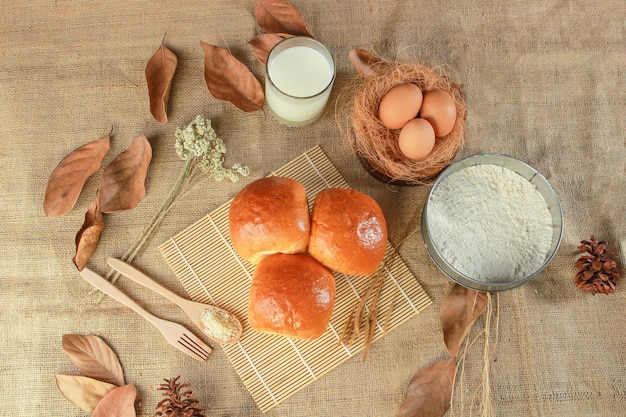 A table with bread eggs and milk on it