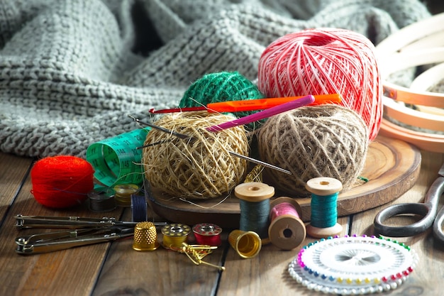 A table with a bunch of yarn and a sewing machine.