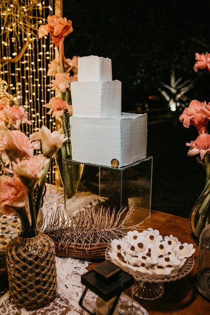 a table with a cake and flowers on it