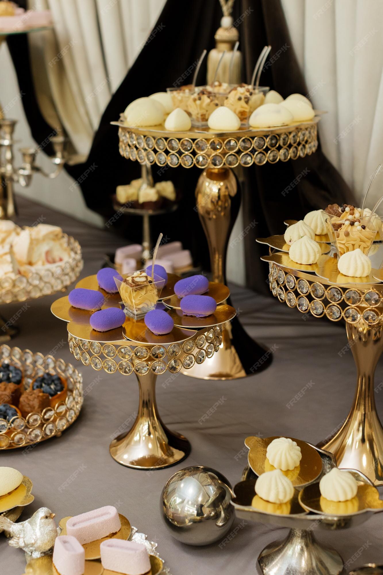 Premium Photo | Table with cakes sweets candy buffet dessert table for a  party goodies for the wedding banquet area close up candy bar decorated  delicious