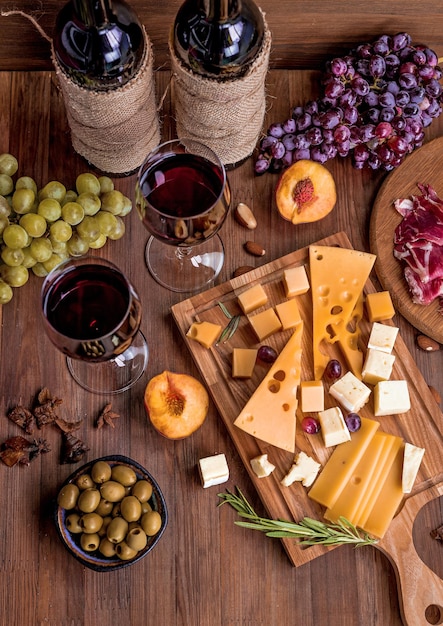 A table with cheese, cheese, and wine glasses