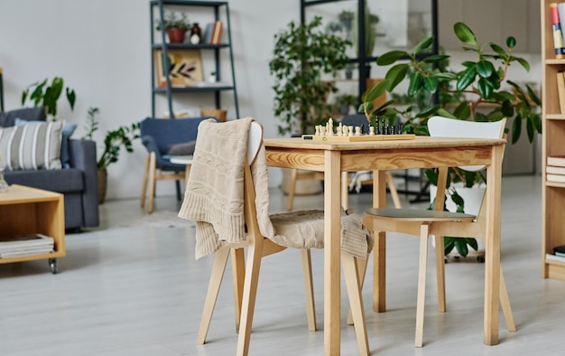 Table with chess board in the room