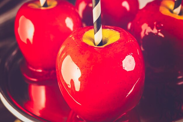 Photo table with colored candy apples for halloween party.