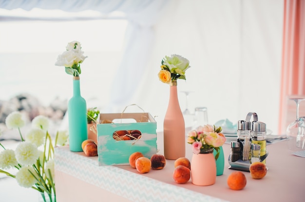 Table with decorative bottles and fruit