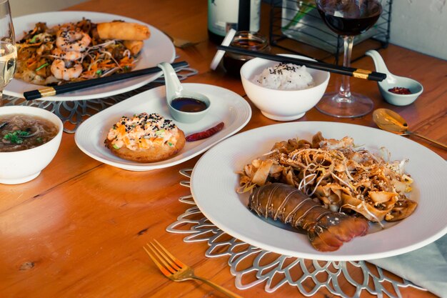 Table with delicious Chinese food, rice and wine. Food and drinks.