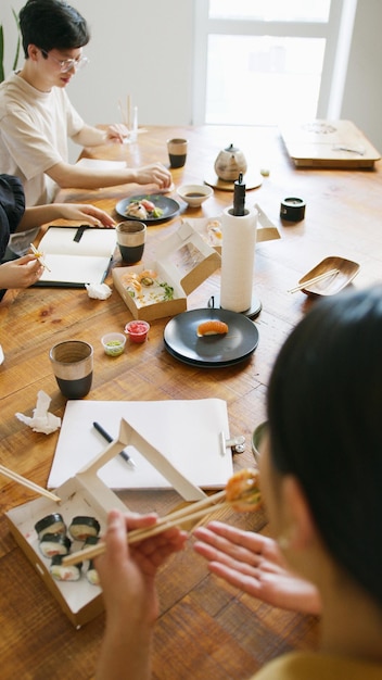 a table with food and a box of sushi on it