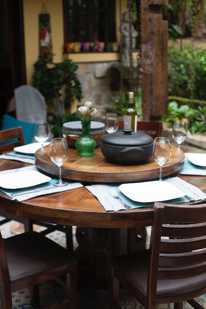 A table with a glass of wine and a bottle of wine on it.