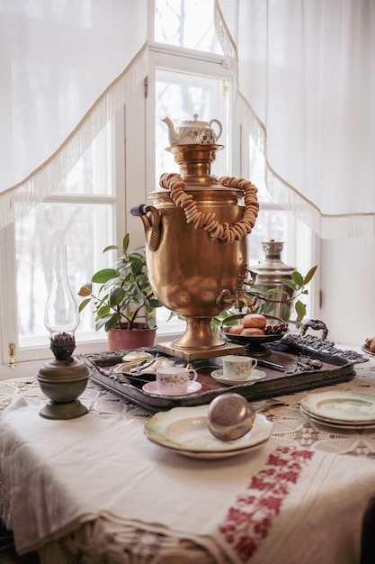 A table with a gold urn and a pot on it