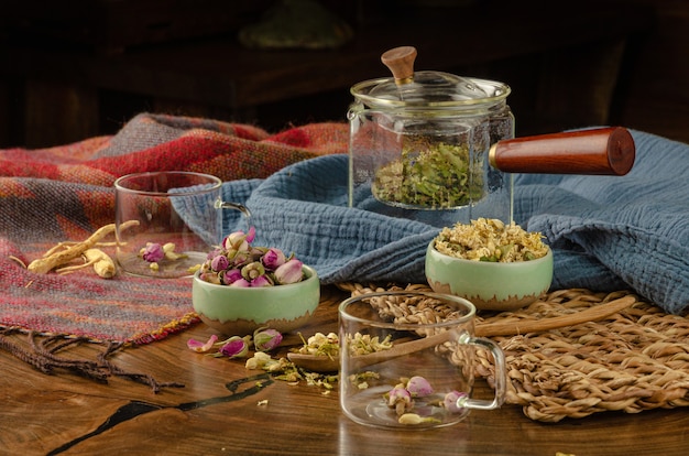 Table with herbal tea and rose petals