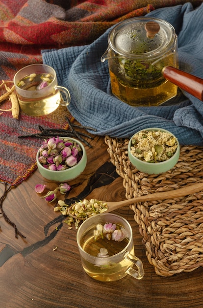 Table with herbal tea and rose petals