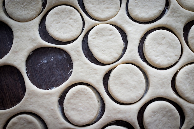 Table with homemade donuts during process