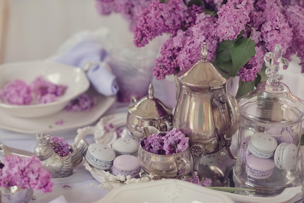 A table with purple flowers and silverware