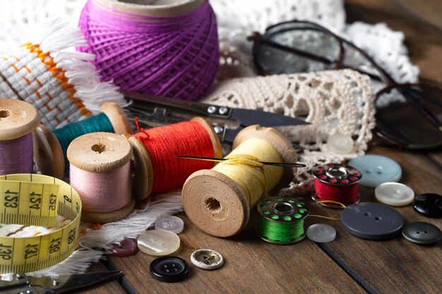 A table with sewing supplies including a pair of glasses, a pair of glasses, a pair of glasses, a pair of glasses, a pair of glasses, a pair of glasses, a pair