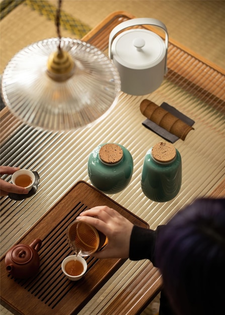 A table with a tea set and a lamp with a light shade