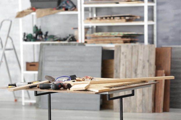 Table with tools in carpenter's workshop