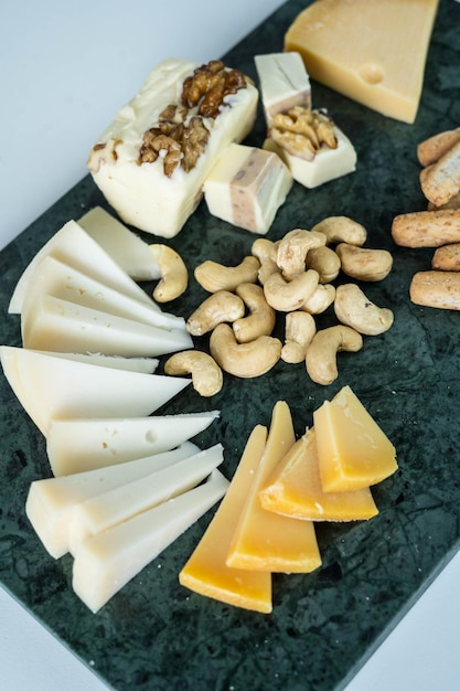 A table with varieties of ripened and soft cheeses