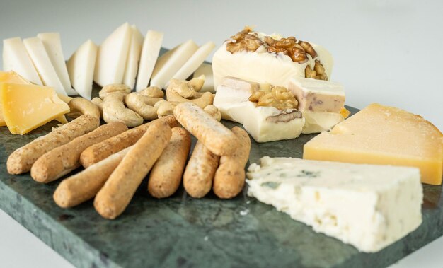 A table with varieties of ripened and soft cheeses