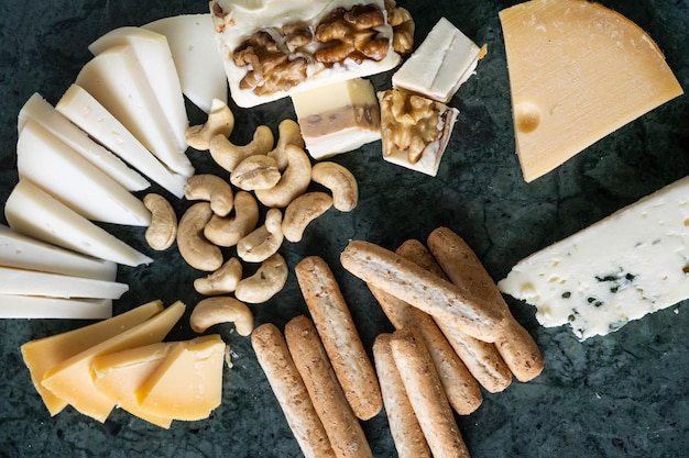 A table with varieties of ripened and soft cheeses