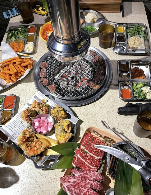 A table with a variety of food including meat, meat, and vegetables.