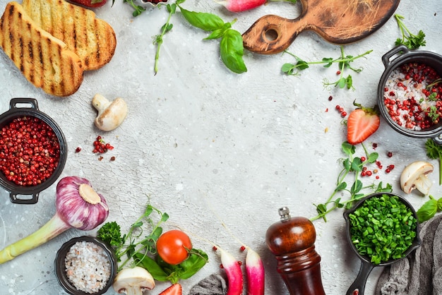 Table with vegetables spices and condiments Preparation for cooking On a stone background Top view