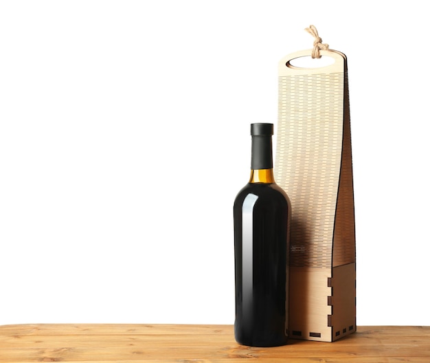 Table with wine bottle and gift box on white background