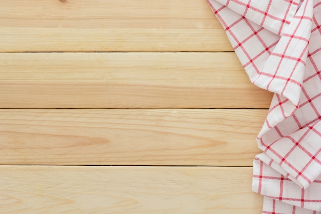 Tablecloth textile, checkered picnic napkin on wooden table background