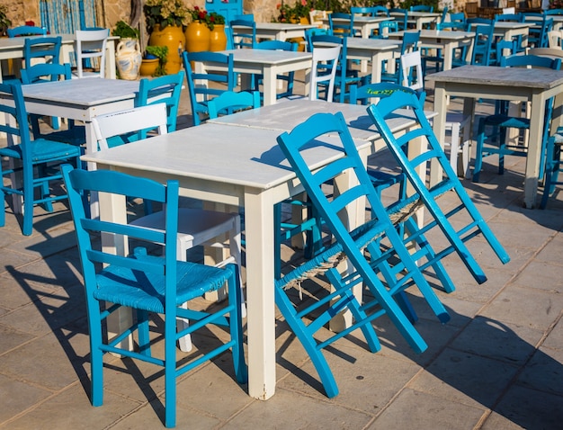 Tables and chairs setup in a traditional Italian restaurant in Marzamemi - Sicily during a sunny day