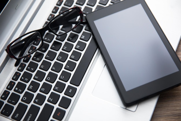 Tablet and glasses on computer