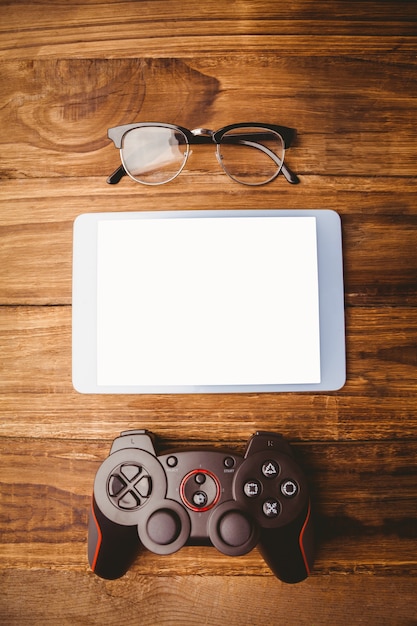 Tablet next to joystick and glasses 