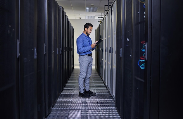Tablet man and engineer in server room research and programming Information technology reading and technician in data center network on cybersecurity and coding software of system admin typing