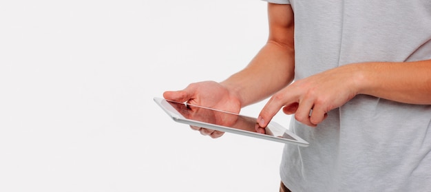 Tablet in men's hands on white background, banner