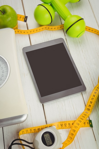 Tablet met indicatoren voor een gezonde levensstijl op houten tafel