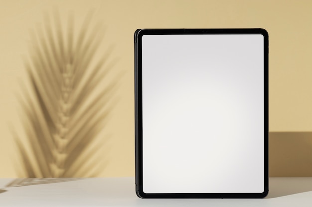 Tablet minimal display with plant shadow