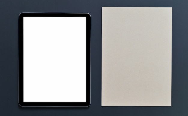 Schermo vuoto mockup tablet e blocco note marrone su fondo nero