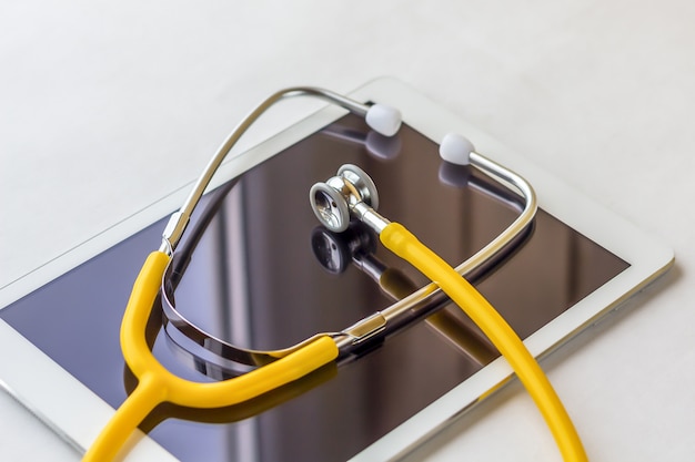 Tablet PC and stethoscope closeup.