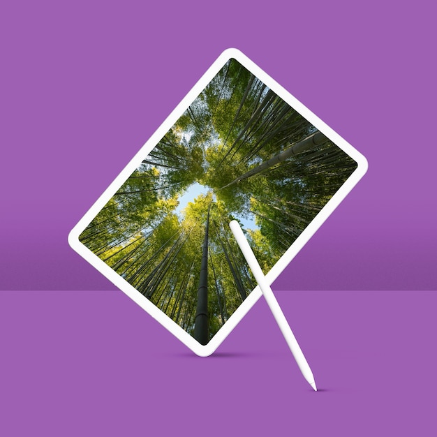 Tablet and pen balancing with purple background