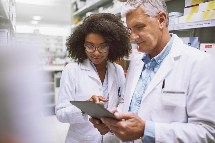 Photo tablet reading and pharmacists with medication in chemist for inventory or stock checking healthcare internship and mentor with pharmaceutical student for medical research on digital technology
