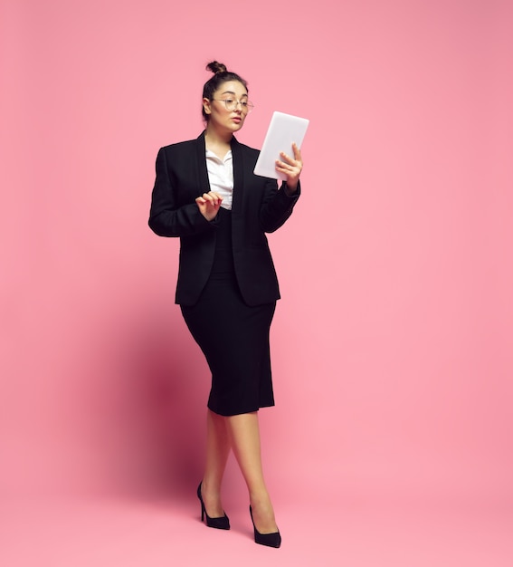 Tablet scrolling. Young woman in office attire. Bodypositive female character, feminism, loving herself, beauty concept. Plus size businesswoman, elegant teacher, beautiful girl. Inclusion, diversity.