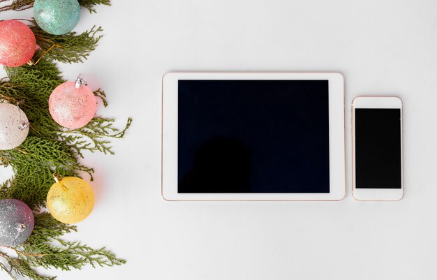 Tablet smart phone mobile display on table. Christmas time.