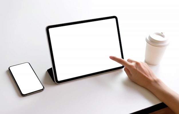 Tablet and smartphone screen blank on the table mockup to promote your products. 