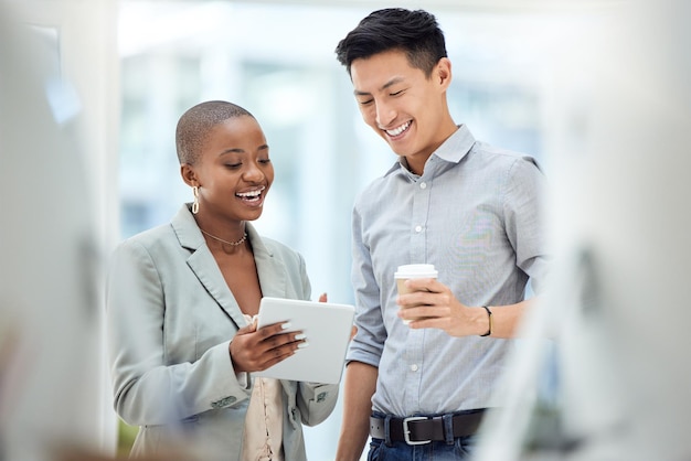 Tablet smile and employees talking about business on the internet online partnership and reading an email together at work Marketing workers with idea for creative collaboration on technology