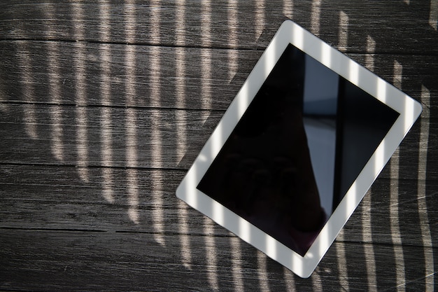 Photo tablet on the table in the shade