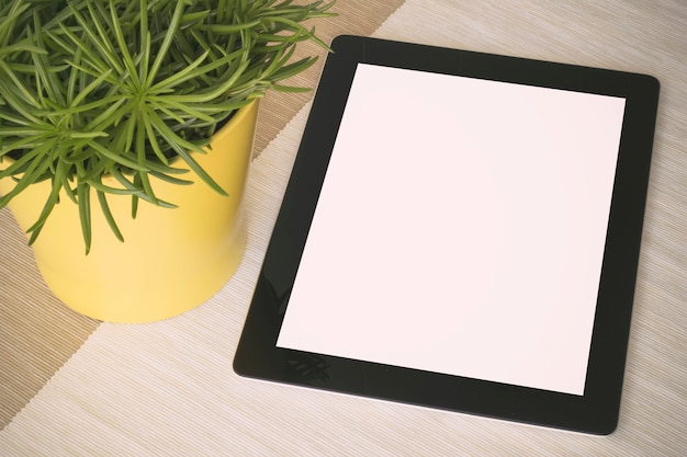 Tablet over a table with plant