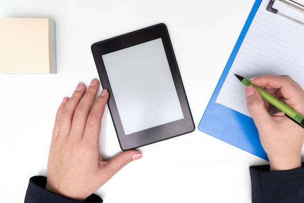 Tablet With Important Message On Desk With Sticky Notes And Clipboard Woman Holding Pen And Writing On Notebook Cellphone Screen With Crutial Announcement