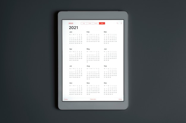 A tablet with an open calendar for 2021 year on a dark gray