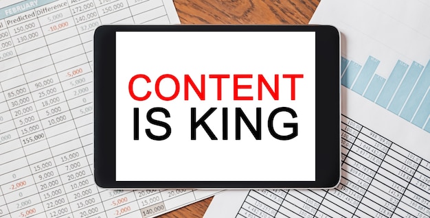 Tablet with text Content is King on your desktop with documents, reports and graphs