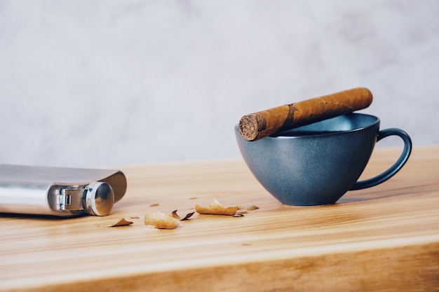 Tabletop with cigar and flask