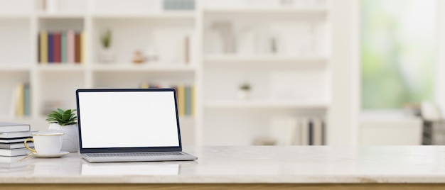 Tabletop with notebook laptop mockup and copy space over blurred modern office room in background