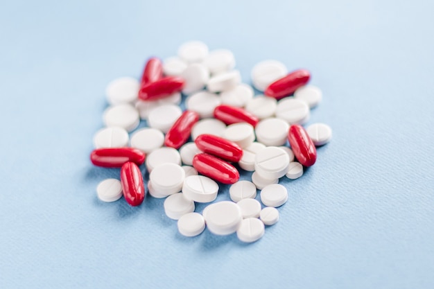 Tablets on a blue surface. The concept of medicine